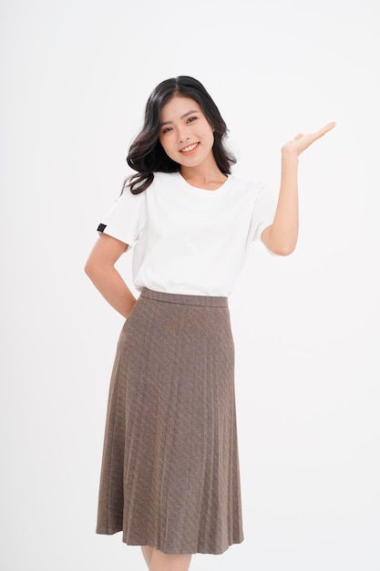 Asian attractive beautiful young woman with hand gesture showing with finger on the copy space isolated on background
