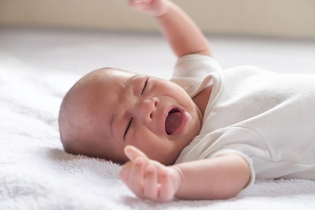 Asian baby cry on bed