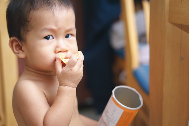 Asian baby eating fried potato chip