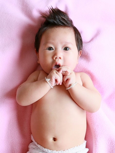 asian baby girl age 3 month in Bed room at home