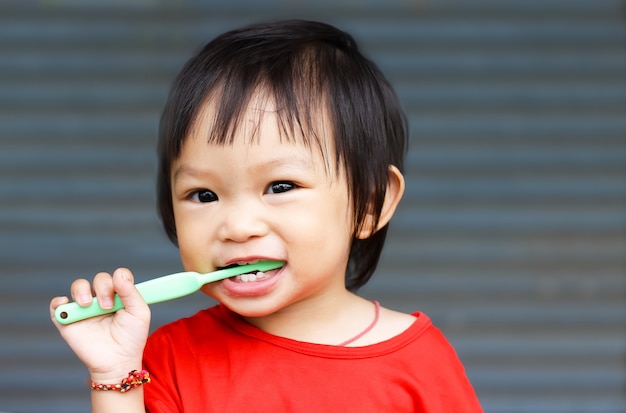 Asian baby girl practice to brushing her teeth. 