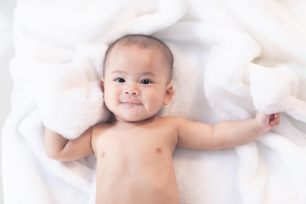 Asian baby inflant sleeping on bed Portrait baby girl studio lighting on fur bed Baby family concept