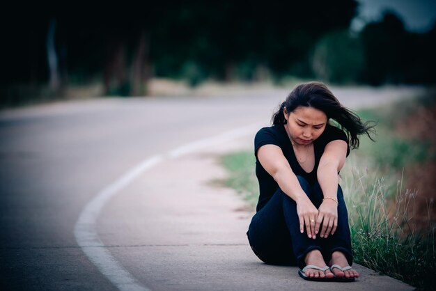 Asian beautiful girl feel alone in the forest,Sad woman concept