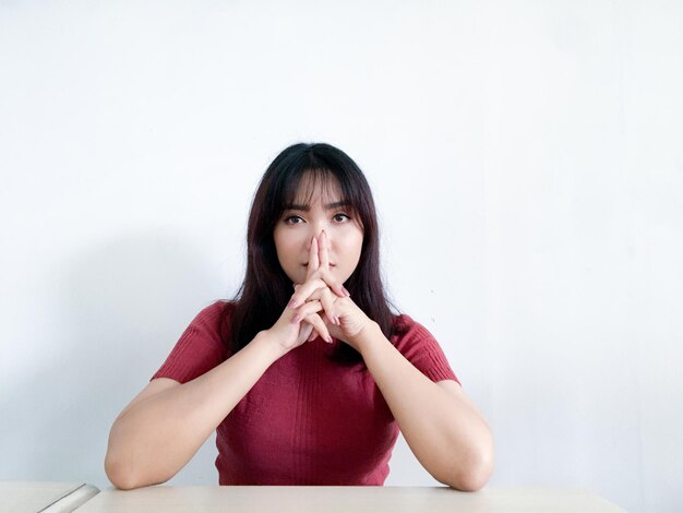 Asian beautiful girl with sharp looking and serious face expression with hand on head