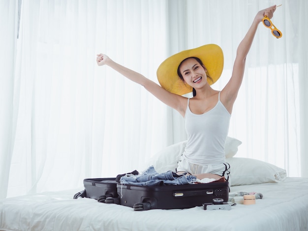 Asian Beautiful woman are preparing bags to go on holiday