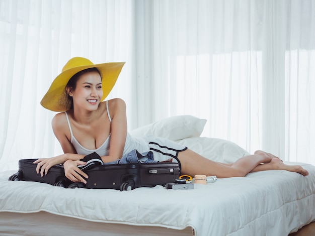 Asian Beautiful woman are preparing bags to go on holiday