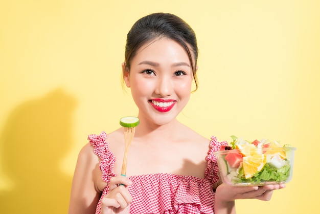 Asian beautiful woman summer outfit posing with fresh bowl of salad