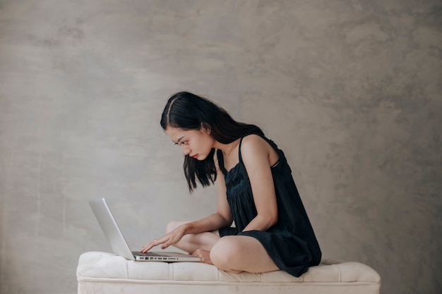 Asian beautiful woman thinking idea with laptop computer