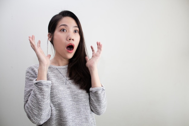 Asian beautiful woman wear green shirt are shocked and surprised with copy space for a promotion and advertisement