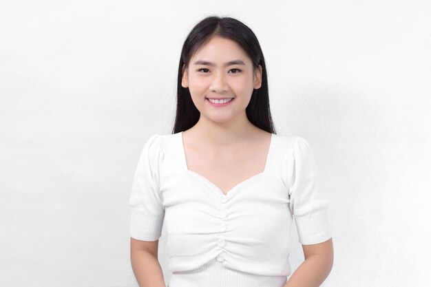 Asian beautiful woman with black long hair in white shirt is smiling on white background