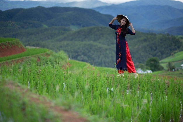 Asian beautiful woman with terraced green rice fields at Ban pa pong piang rice terraces of Chiang Mai Thailand