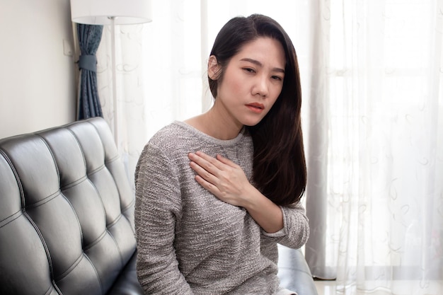 Photo asian beautiful women touch chest heart attack symptom pain from heart stroke a healthcare and medical concept