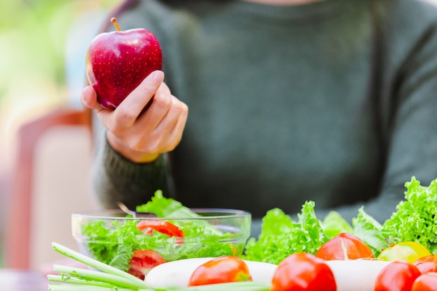 アジアの美しい若い女の子のサラダ野菜を食べる