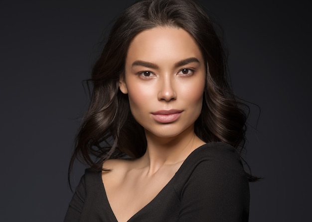 Asian beauty female black background curly black hair natural make up. Studio shot.