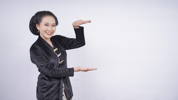 Asian beauty in kebaya pointing blankly isolated on white background