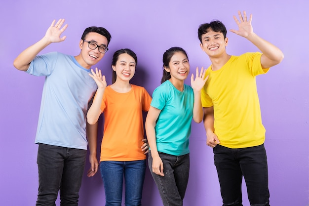 Asian best friends posing on purple background