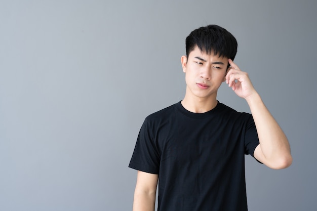 Asian boy in black t-shirt standing