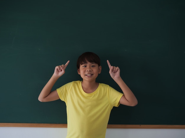 Asian boy in classroom backboard background