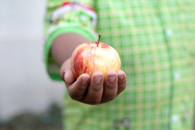 Asian boy holding an apple