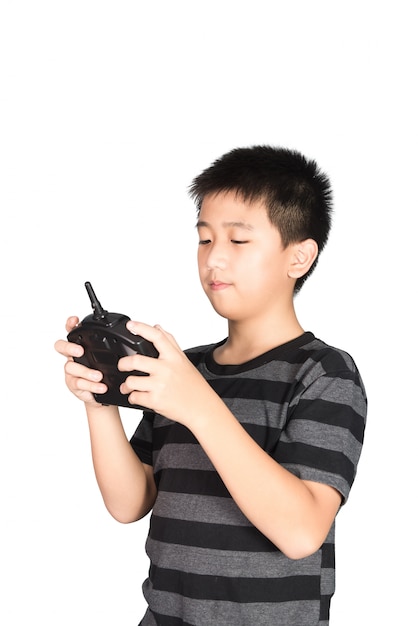 Asian boy holding radio remote control handset for toy