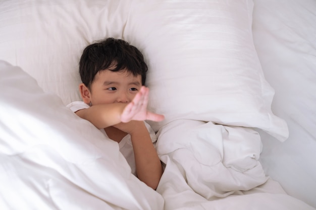 Asian boy at home on the bed