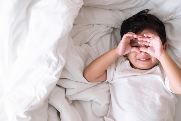 Asian boy at home on the bed