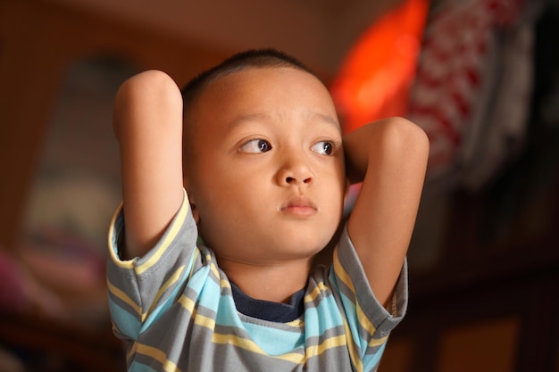 Asian boy looking up at the room