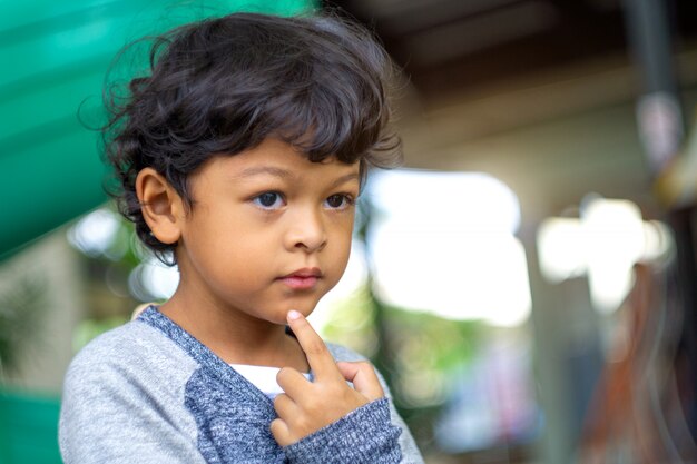 Asian boy looks forward and makes an idea.