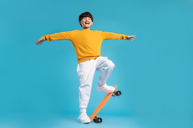 Asian boy portrait posing on blue background