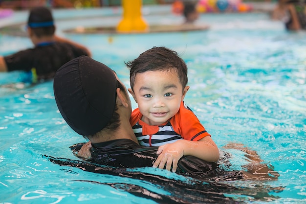 Asian boy swimming, portrait on swimming pool background