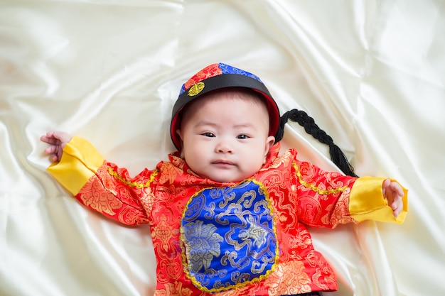 伝統的な中国のスーツ、白い背景、中国の新年のコンセプトのアジアの少年。