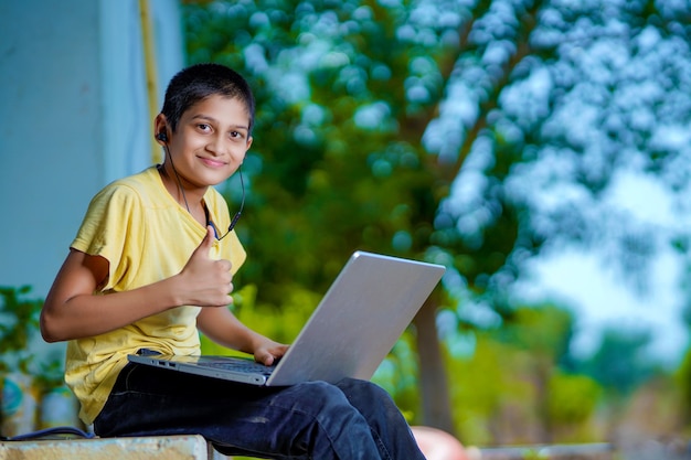 Asian boy using Laptop computer for online study homeschooling during home quarantine. homeschooling, online study, home quarantine, online learning, corona virus or education technology concept