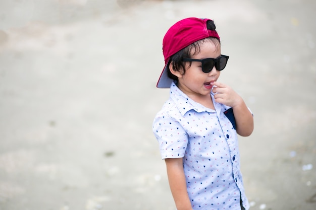 Asian boy walking the tropical beach, Happy little boy walking near the sea