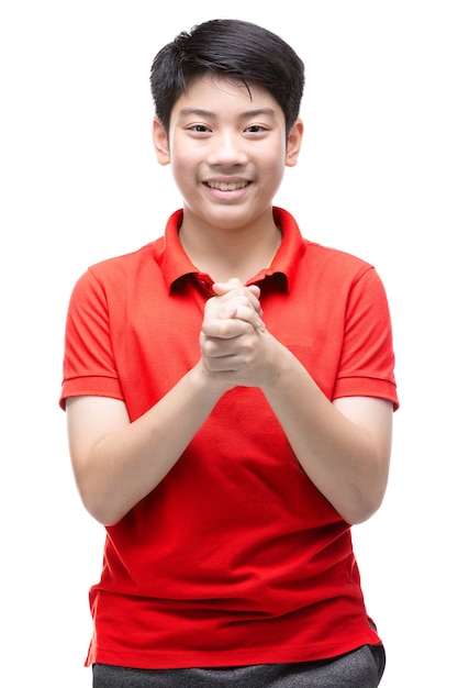 Asian boy wearing a red shirt praying