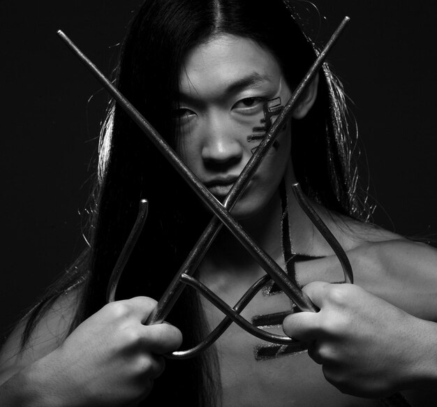 Photo asian boy with weapons