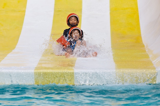 Asian boys playing in water park