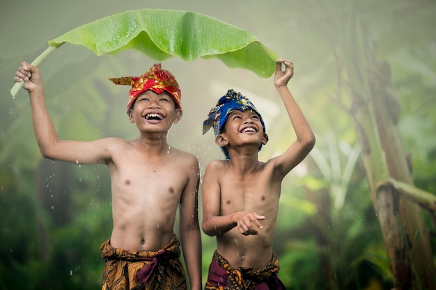 Asian boys teens laughing outdoors romance friendship love in the summer. happy face and beautiful nature.