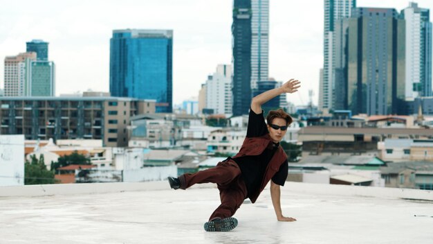 Asian break dancer practice B boy dance with friends at roof top Endeavor