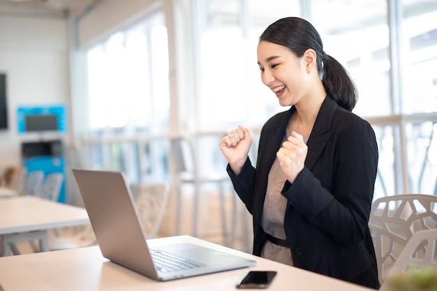 Asian business girl with laptop success happy pose Ecommerce University education