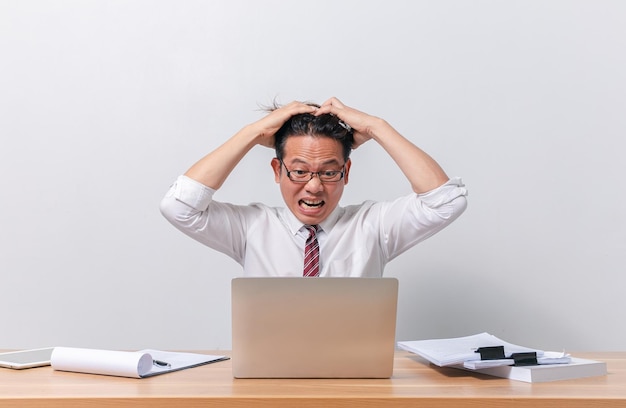 Asian business man sitting and working and stressed