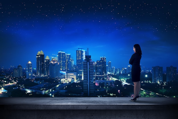 Asian business person standing on the rooftop