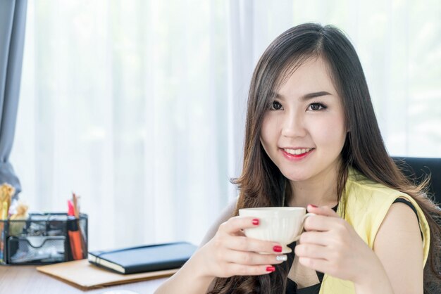 asian business woman happy with coffee cup 