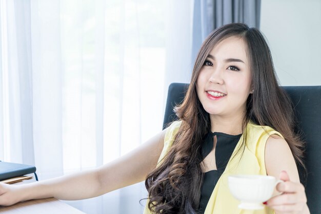 asian business woman happy with coffee cup 