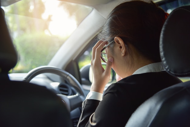 Asian business woman having headache.