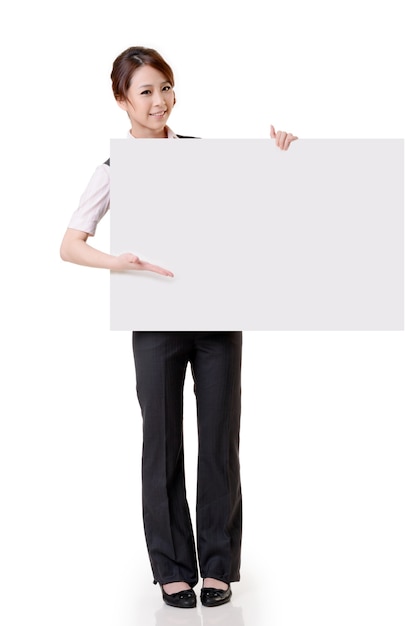 Asian business woman hold empty blank board, full length portrait isolated on white wall.