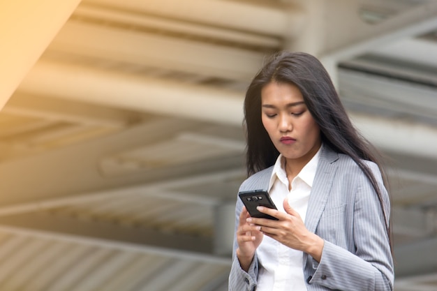 Asian business woman looking mobile