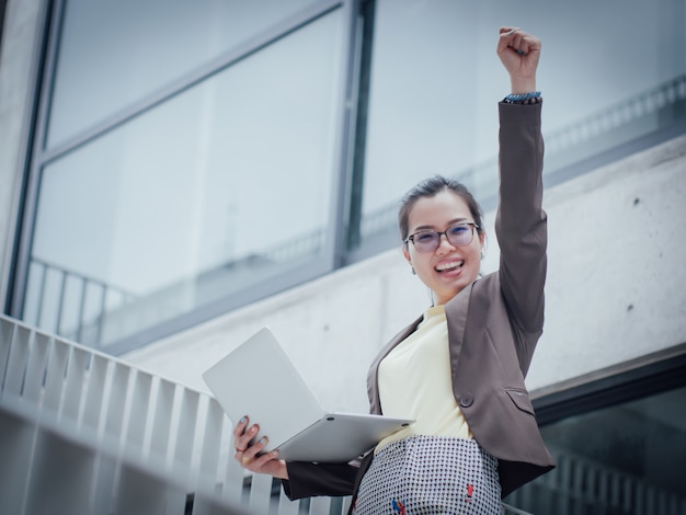 Asian business woman with laptop happy and smile concept success work 