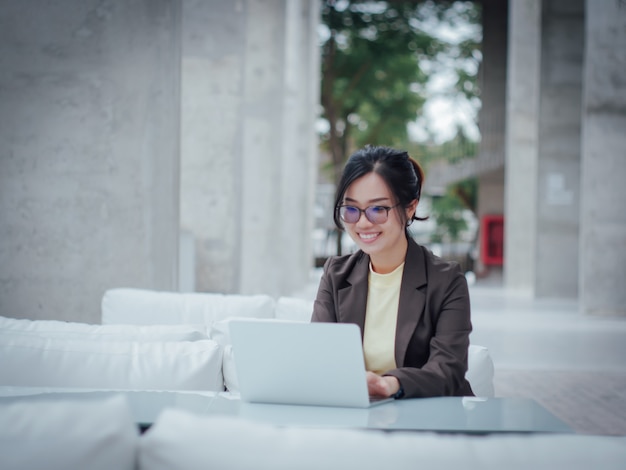 Asian business woman with laptop happy and smile concept success work 
