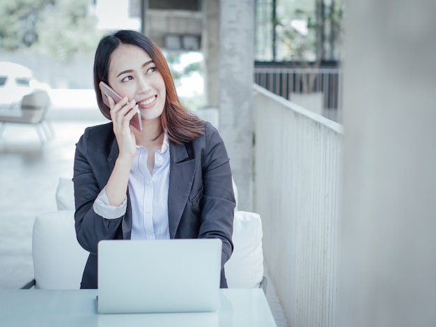 Asian business woman with laptop happy and smile concept success work 