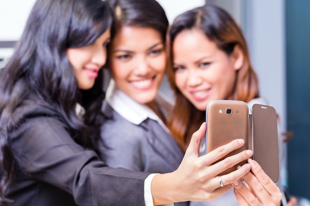 Asian Business women taking selfie with smart phone